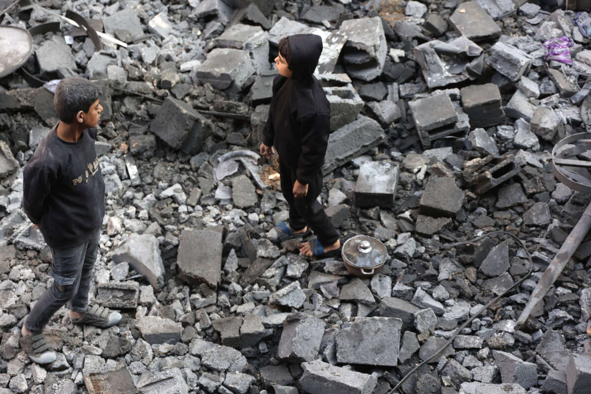 Palestinian children inspect the damage at the site of an Israeli strike the previous night, in Jabalia, in the central Gaza Strip on January 1, 2025.