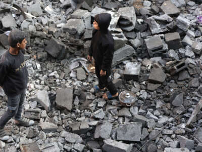 Palestinian children inspect the damage at the site of an Israeli strike the previous night, in Jabalia, in the central Gaza Strip on January 1, 2025.