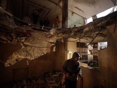 People search the rubble of a building destroyed in an Israeli strike in Deir el-Balah in the central Gaza Strip on January 9, 2025.