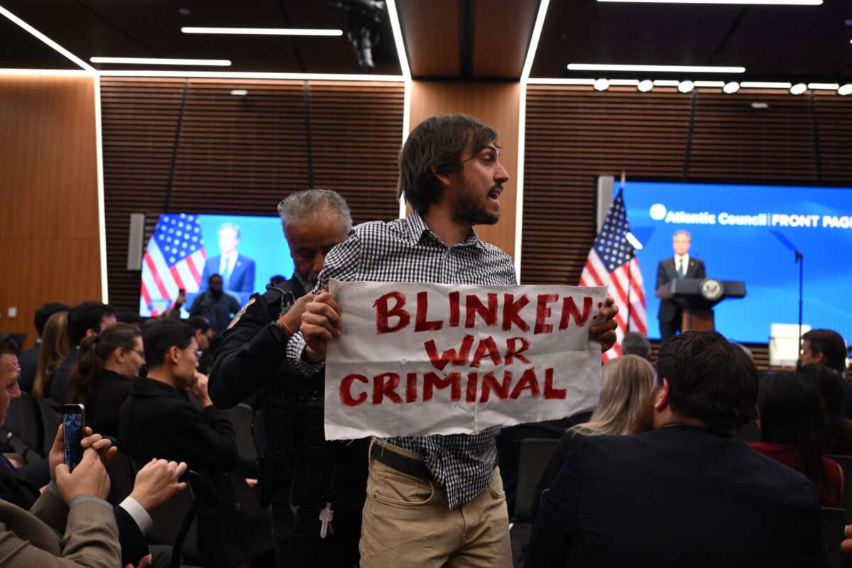 A Pro-Palestinian protester is removed from the room as U.S. Secretary of State Antony Blinken speaks at the Atlantic Council in Washington, D.C., on January 14, 2025.