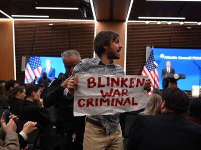 A Pro-Palestinian protester is removed from the room as U.S. Secretary of State Antony Blinken speaks at the Atlantic Council in Washington, D.C., on January 14, 2025.