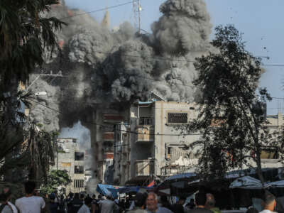 Thick smoke billows from a residential building in Bureij refugee camp after it was hit by an Israeli airstrike, in Deir al-Balah, Palestinian Territories, on June 3, 2024.