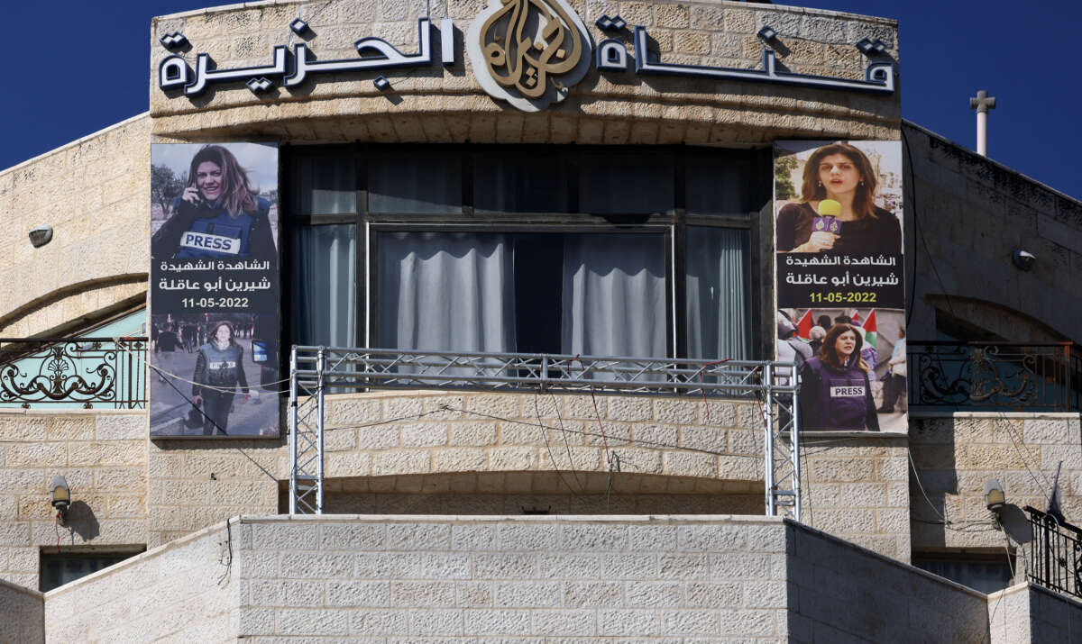 Pictures of slain Palestinian journalist Shireen Abu Akleh are hung across the facade of the building housing the Doha-based Al-Jazeera TV channel in the occupied-West Bank city of Ramallah on January 2, 2025.