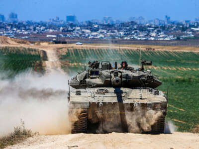 An Israeli army battle tank moves near the border with the Gaza Strip in southern Israel on May 16, 2024.