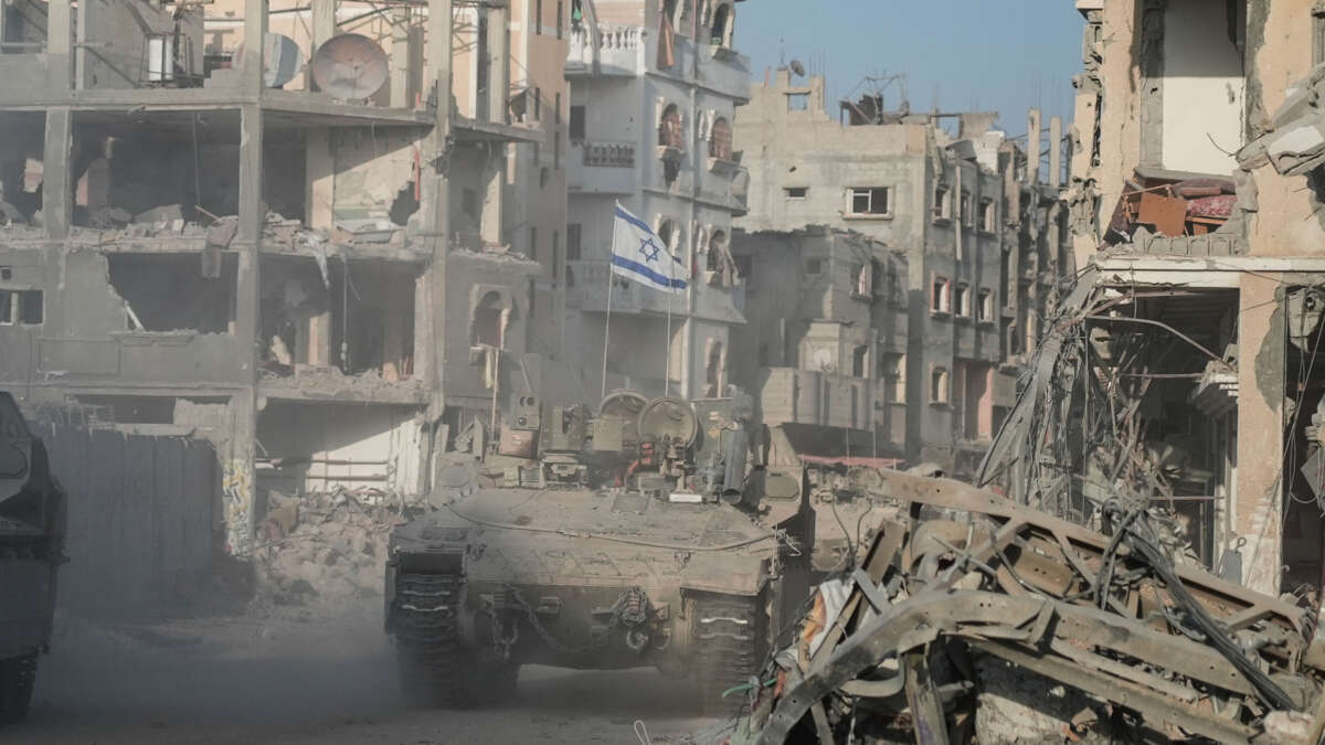 Israeli soldiers drive past destroyed buildings in Rafah in the Gaza Strip on September 13, 2024.