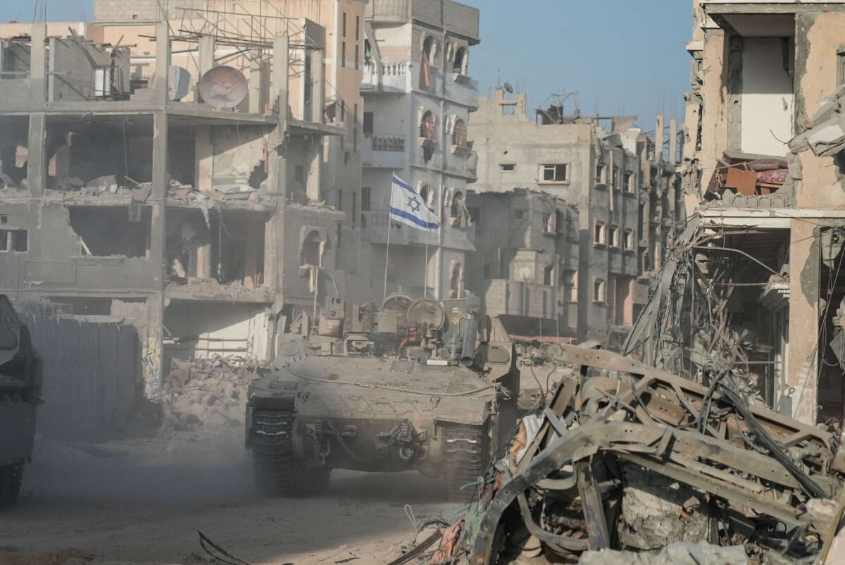 Israeli soldiers drive past destroyed buildings in Rafah in the Gaza Strip on September 13, 2024.