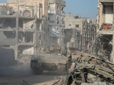 Israeli soldiers drive past destroyed buildings in Rafah in the Gaza Strip on September 13, 2024.