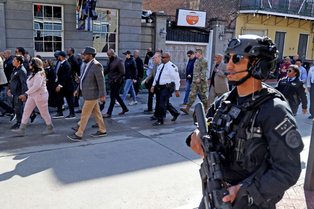 Members of the New Orleans Mayor's Office, law enforcement and local clergy make a peace walk down Bourbon Street, stopping in the 500 block to pray for the victims of the New Year's Day attack as the street prepares to reopen on January 2, 2025, in New Orleans, Louisiana.