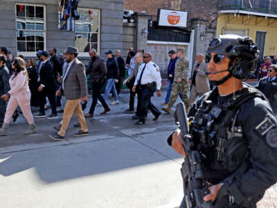 Members of the New Orleans Mayor's Office, law enforcement and local clergy make a peace walk down Bourbon Street, stopping in the 500 block to pray for the victims of the New Year's Day attack as the street prepares to reopen on January 2, 2025, in New Orleans, Louisiana.