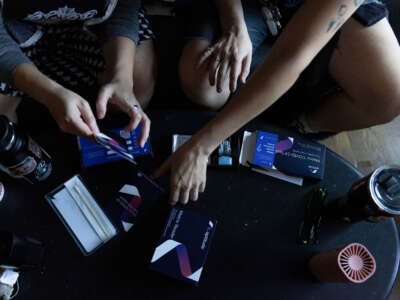 People read directions for a home PCR Covid test in an apartment in Atlanta, Georgia, on August 31, 2024.