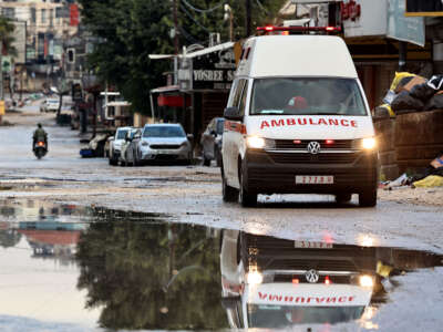 An ambulance drives in the Jenin camp, in the Israeli-occupied West Bank, on November 19, 2024.