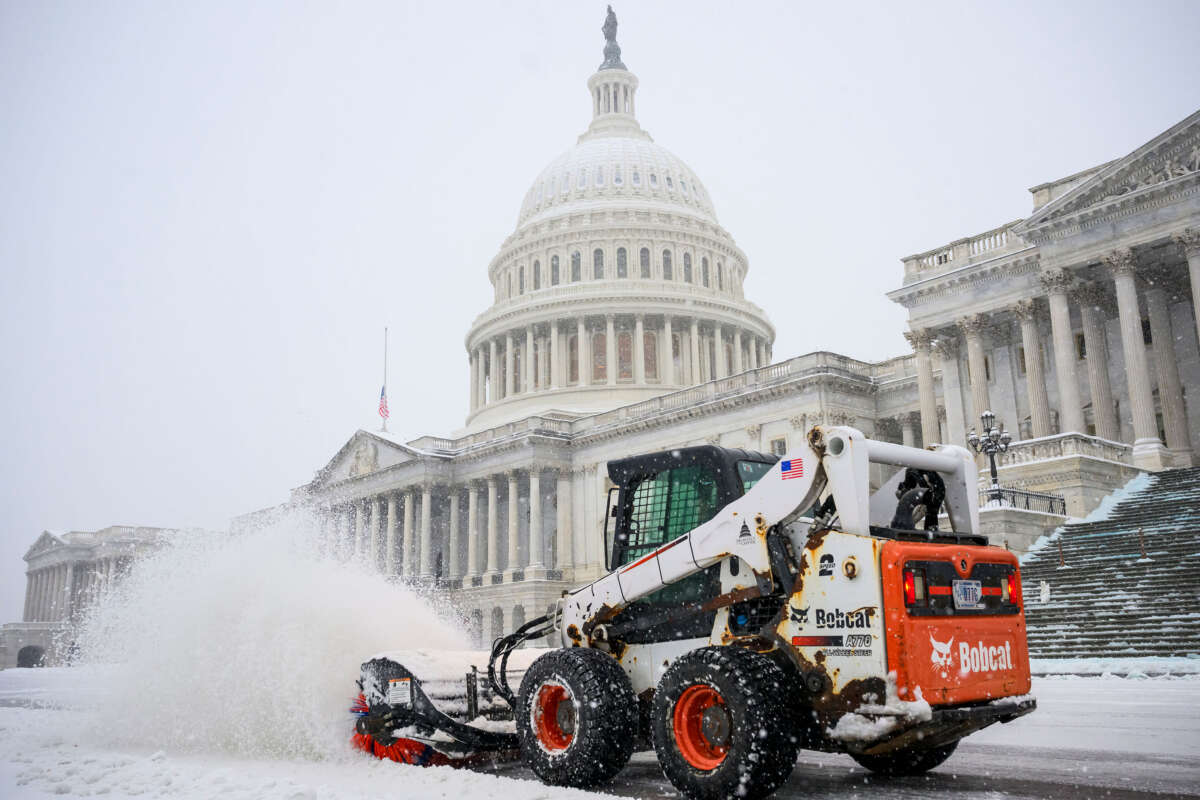 A man uses a 'Bobcat' compact track loader to plow snow before Senators and Representatives attend a joint session of Congress to certify the Electoral College votes of the 2024 presidential election in the House chamber on January 6, 2025, at the U.S. Capitol in Washington, D.C.