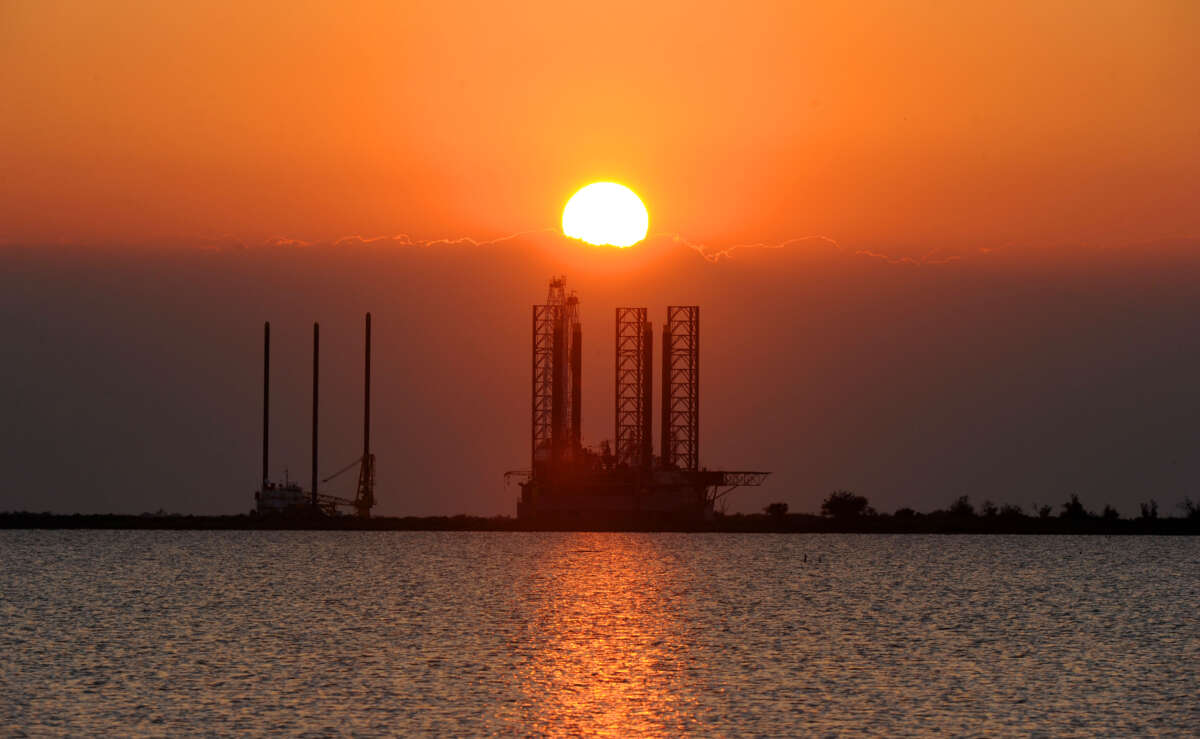 The sun sets over an oil platform waiting to be towed out into the Gulf of Mexico at Port Fourchon in Louisiana, on May 4, 2010.