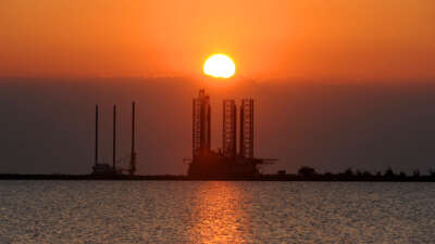 The sun sets over an oil platform waiting to be towed out into the Gulf of Mexico at Port Fourchon in Louisiana, on May 4, 2010.