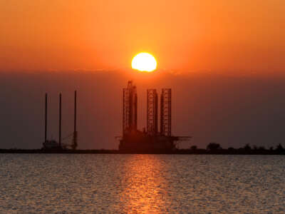 The sun sets over an oil platform waiting to be towed out into the Gulf of Mexico at Port Fourchon in Louisiana, on May 4, 2010.