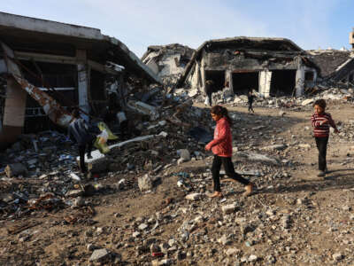 Palestinian children run amid the destruction in the Shujaiya neighbourhood of Gaza City, in the northern Gaza Strip on January 4, 2025.