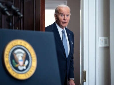 Joe Biden, looking surprised at something, exits through a door