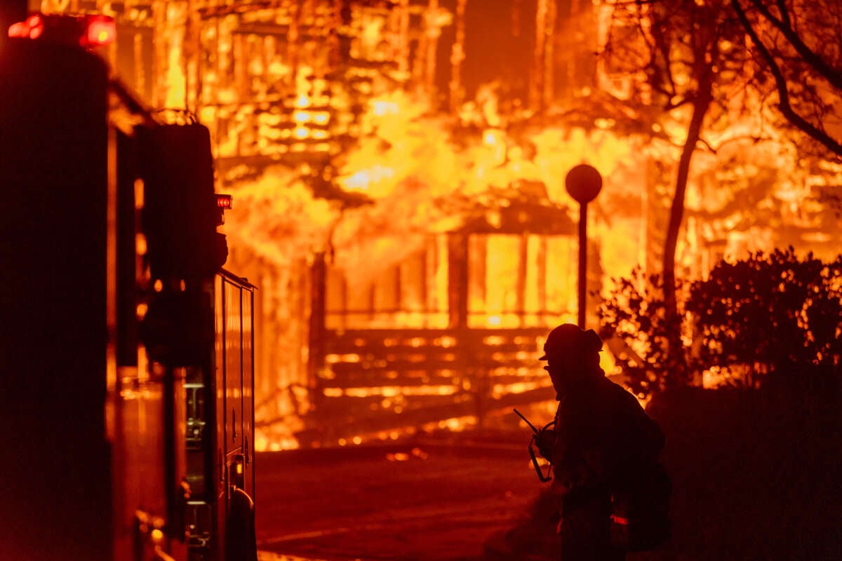 Firefighters battle the Eaton Fire in strong winds as many homes burn on January 7, 2025, in Pasadena, California.