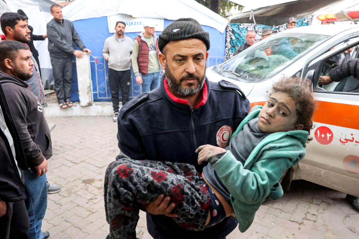 A man carries a girl that was rescued from the rubble of a collapsed building to receive medical care at the Ahli Arab hospital, also known as the Baptist hospital, in Gaza City on January 4, 2025.