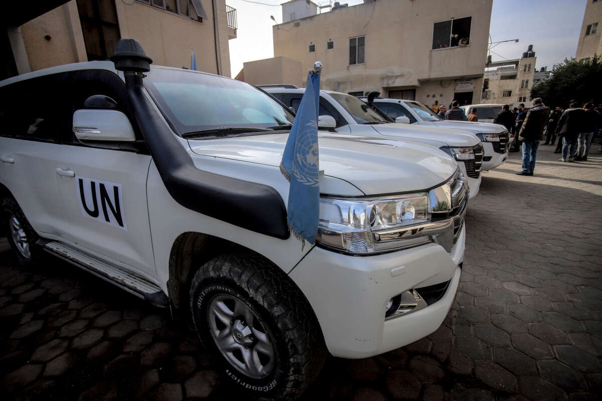 A United Nations vehicle with a blue flag is parked on a cobblestone street in Gaza on December 11, 2024.