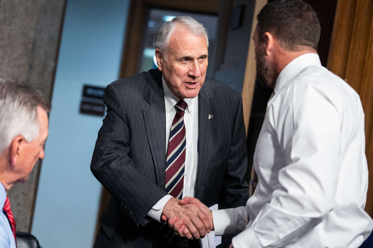 John Kyl shakes someone's hand