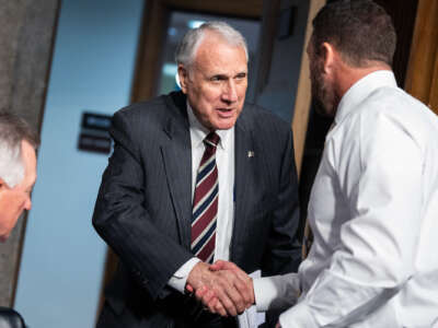 John Kyl shakes someone's hand