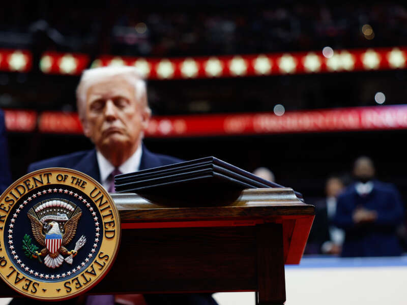 President Donald Trump signs executive orders during an indoor inauguration parade at Capital One Arena on January 20, 2025, in Washington, D.C.