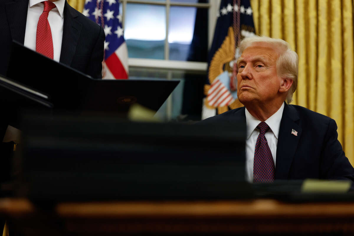 President Donald Trump signs executive orders in the Oval Office on January 20, 2025, in Washington, D.C.