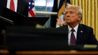 President Donald Trump signs executive orders in the Oval Office on January 20, 2025, in Washington, D.C.