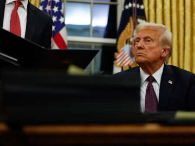 President Donald Trump signs executive orders in the Oval Office on January 20, 2025, in Washington, D.C.