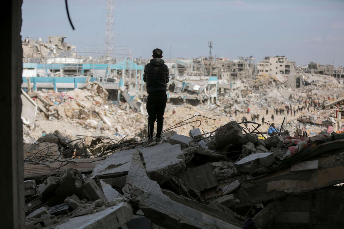 A boy stands amidst the rubble of a destroyed building looking into the distance in Gaza City on January 19, 2025.