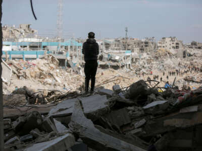 A boy stands amidst the rubble of a destroyed building looking into the distance in Gaza City on January 19, 2025.