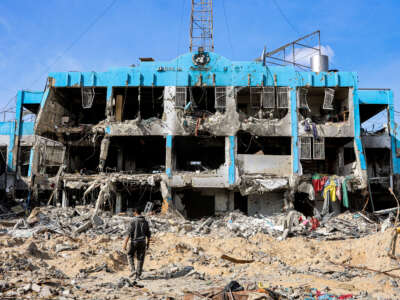 A man walks outside a destroyed building that was a clinic for the United Nations Relief and Works Agency for Palestine Refugees (UNRWA) at the Jabalia camp for Palestinian refugees in the northern Gaza Strip on January 19, 2025.