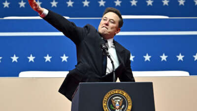 Tesla and SpaceX CEO Elon Musk gestures as he speaks during the inaugural parade inside Capitol One Arena, in Washington, D.C., on January 20, 2025.