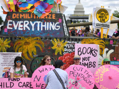 Many political signs are placed during The Poor People's Campaign rally in Washington, D.C., on June 18, 2022.