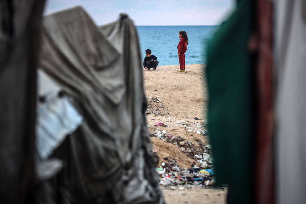 Displaced Palestinian children play outside their tents near the seaside in Deir al-Balah, central Gaza Strip, on January 22, 2025, following a ceasefire between Israel and Hamas.