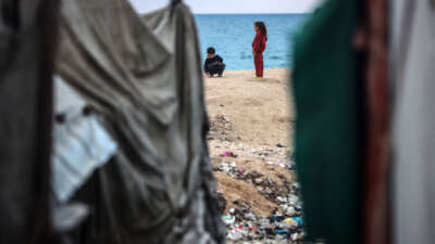 Displaced Palestinian children play outside their tents near the seaside in Deir al-Balah, central Gaza Strip, on January 22, 2025, following a ceasefire between Israel and Hamas.