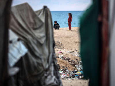 Displaced Palestinian children play outside their tents near the seaside in Deir al-Balah, central Gaza Strip, on January 22, 2025, following a ceasefire between Israel and Hamas.