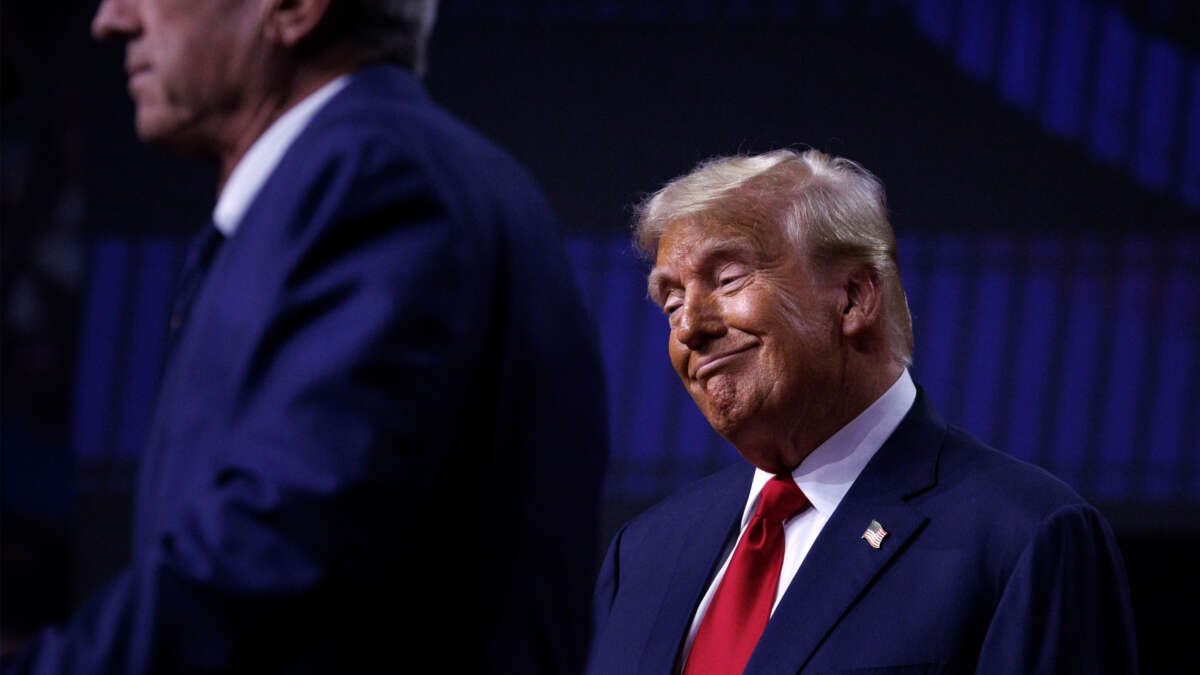 Robert F. Kennedy Jr. speaks on stage beside Republican presidential nominee Donald Trump during a campaign event at Desert Diamond Arena in Glendale, Arizona, on August 23, 2024.