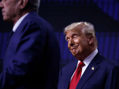 Robert F. Kennedy Jr. speaks on stage beside Republican presidential nominee Donald Trump during a campaign event at Desert Diamond Arena in Glendale, Arizona, on August 23, 2024.