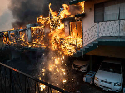 An apartment building collapses from the fire due to the Eaton Fire in Altadena, California, on January 8, 2025.