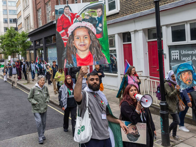 A demonstrator in solidarity with Palestinians holds up a painted image of Hind Rajab, a 6-year-old Palestinian girl killed in Gaza City in January 2024, and two Palestinian Red Crescent Society paramedics, before a national demonstration to mark the 76th anniversary of the Nakba on May 18, 2024 in London, United Kingdom.