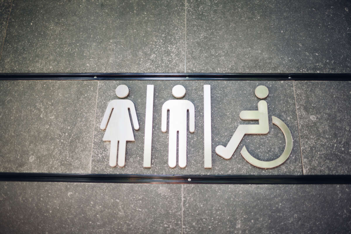 Restroom sign with figures for male, female and disabled people.