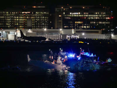 Emergency response units assess airplane wreckage in the Potomac River near Ronald Reagan Washington Airport on January 30, 2025, in Arlington, Virginia.