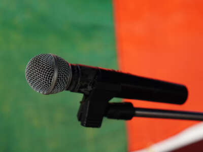 Microphone in front of green and red backdrop