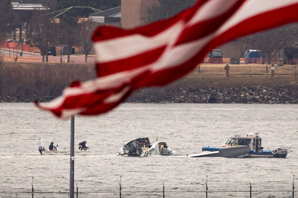 Recovery teams search the wreckage after the crash of an American Airlines plane on the Potomac River as it approached the airport on January 31, 2025, in Arlington, Virginia.