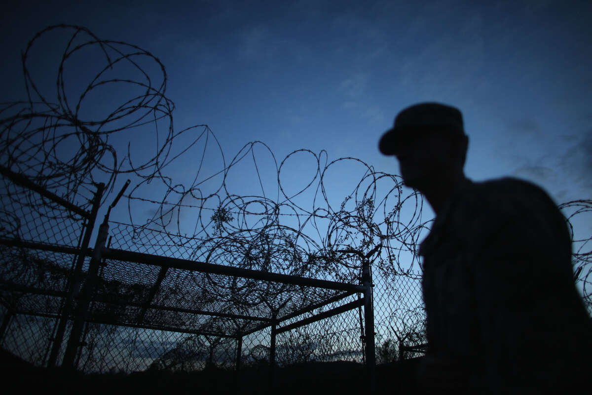 A public affairs officer escorts media through the currently closed Camp X-Ray, which was the first detention facility to hold "enemy combatants" at the U.S. Naval Station on June 27, 2013, in Guantanamo Bay, Cuba.