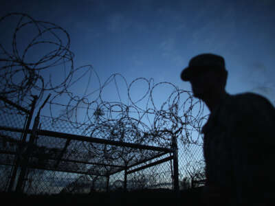 A public affairs officer escorts media through the currently closed Camp X-Ray, which was the first detention facility to hold "enemy combatants" at the U.S. Naval Station on June 27, 2013, in Guantanamo Bay, Cuba.