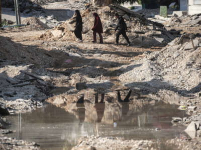 A Palestinian family leaves their home in the Jenin refugee camp in the northern West Bank following a military operation carried out by the Israeli army in Jenin, West Bank, Palestine, on January 27, 2025.