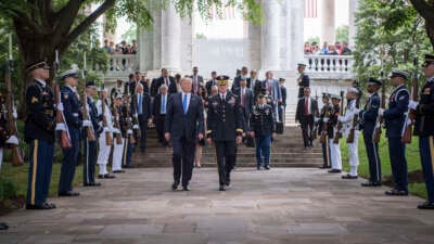 President Donald Trump leaves after attending a Memorial Day ceremony at Arlington National Cemetery in Arlington, Virginia, May 28, 2017. Two military aides carrying two “nuclear footballs” can be seen walking behind and to the right of Trump.